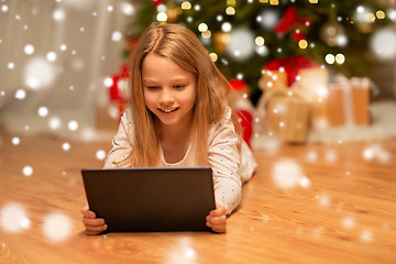Image showing smiling girl with tablet pc at christmas home