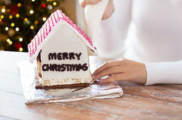 Image showing woman making gingerbread house on christmas