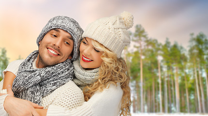 Image showing couple hugging over winter forest background