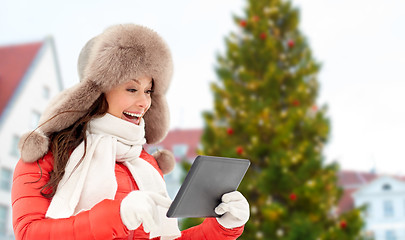 Image showing woman with tablet pc over christmas tree