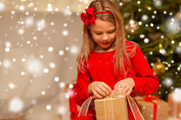 Image showing smiling girl with christmas gift at home