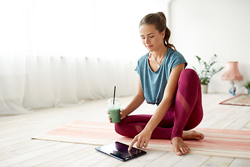 Image showing woman with tablet pc and drink at yoga studio