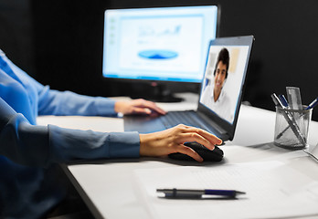 Image showing businesswoman having video call on laptop at night