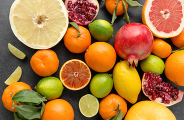 Image showing close up of citrus fruits on stone table