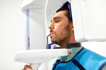 Image showing patient having x-ray scanning at dental clinic