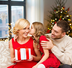 Image showing happy family with christmas gift at home