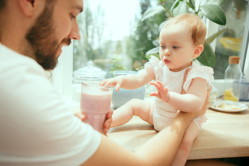 Image showing The happy smiling caucasian family in the kitchen preparing breakfast