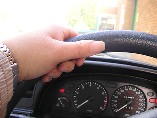 Image showing left hand on steering wheel