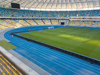 Image showing KYIV, UKRAINE - July 19, 2018. NSC Olimpiysky - the inside part with a football field, tribunes and treadmills.