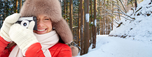 Image showing happy woman with film camera over winter forest