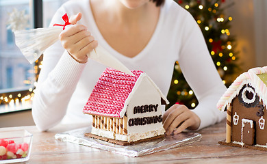 Image showing woman making gingerbread house on christmas