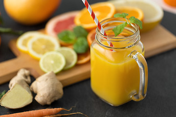 Image showing mason jar glass of fruit juice on slate table top