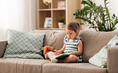 Image showing little girl reading book at home