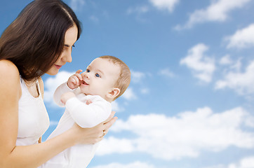 Image showing mother with baby over sky background