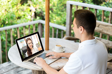 Image showing man having video call with operator on laptop