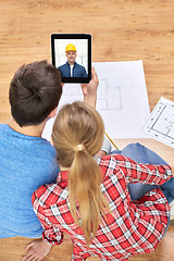 Image showing couple having video call with builder