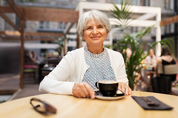 Image showing senior woman with coffee at street cafe