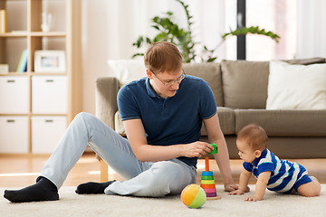 Image showing happy father with little baby son playing at home