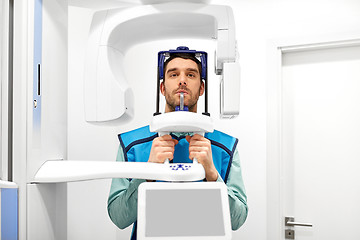 Image showing patient having x-ray scanning at dental clinic