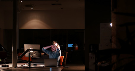 Image showing businessman relaxing at the desk