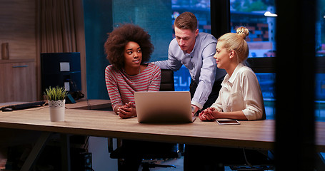 Image showing Multiethnic startup business team in night office