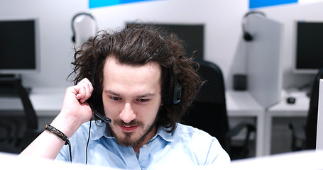 Image showing male call centre operator doing his job