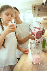 Image showing The happy smiling caucasian family in the kitchen preparing breakfast