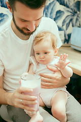 Image showing The happy smiling caucasian family in the kitchen preparing breakfast