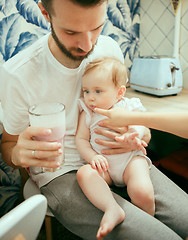 Image showing The happy smiling caucasian family in the kitchen preparing breakfast