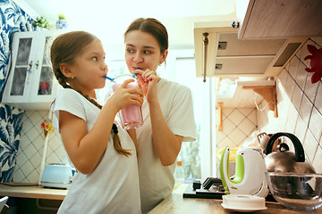 Image showing The happy smiling caucasian family in the kitchen preparing breakfast