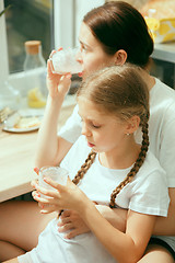 Image showing The happy smiling caucasian family in the kitchen preparing breakfast