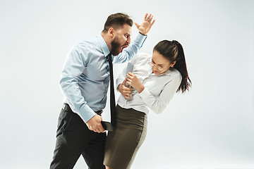 Image showing angry businessman and his colleague in the office.