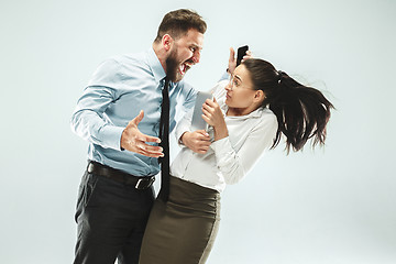 Image showing angry businessman and his colleague in the office.