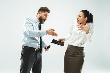 Image showing a business man shows the laptop to his colleague in the office.