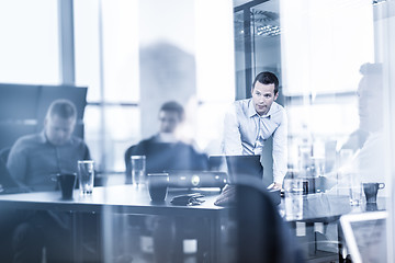 Image showing Business team brainstorming on meeting in modern corporate office.