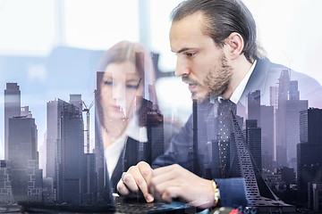 Image showing Business people in modern office against new york city manhattan buildings and skyscrapers window reflections.