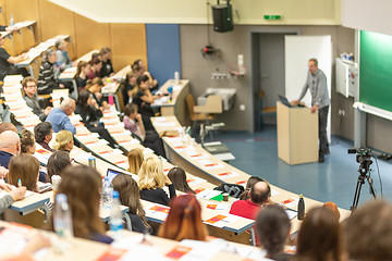 Image showing Expert speaker giving a talk at scientific business conference event.