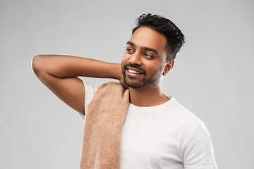 Image showing smiling indian man with towel over grey background