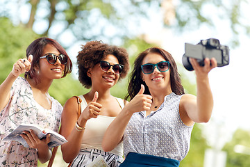 Image showing women with map travelling and recording video blog