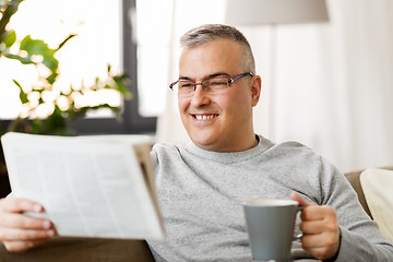 Image showing man reading newspaper and drinking coffee at home