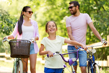 Image showing happy family with bicycles in summer park