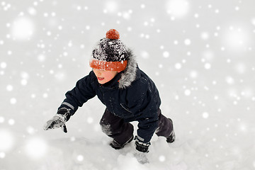 Image showing happy little boy in winter clothes outdoors