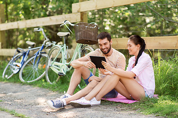 Image showing couple with tablet pc and bicycles at summer park