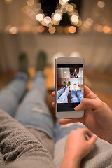 Image showing close up of couple taking foot photo by smartphone