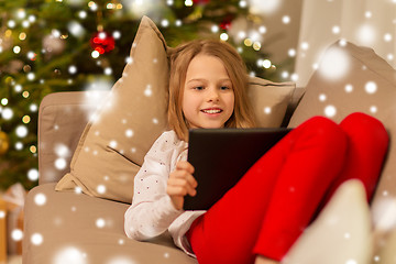 Image showing smiling girl with tablet pc at christmas home