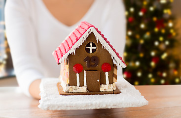 Image showing close up of woman with christmas gingerbread house