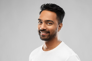 Image showing smiling young indian man over gray background