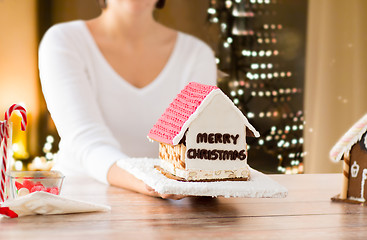 Image showing close up of woman with christmas gingerbread house