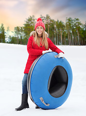 Image showing happy teenage girl with snow tube in winter