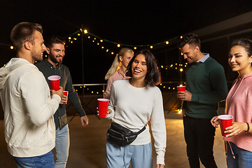 Image showing friends with drinks dancing at rooftop party